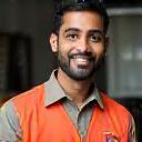 Rakesh Shetty smiling in uniform