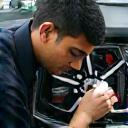 Santosh Kumar cleaning car wheels