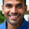 Aadesh Mehta smiling by his clean car