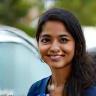 Shweta Banerjee beaming beside her hatchback